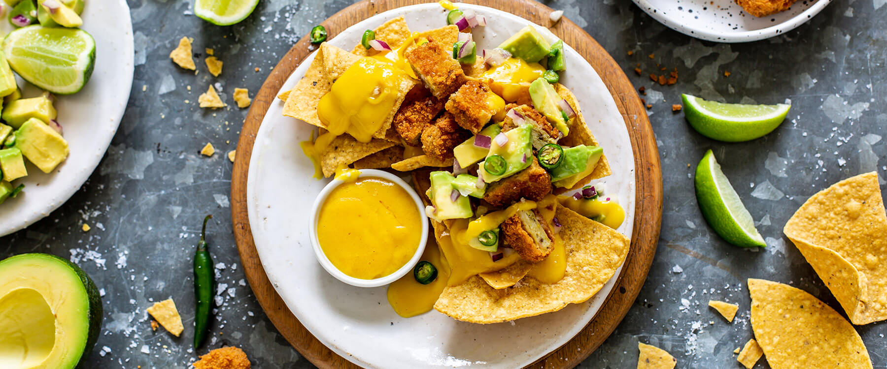 Cheesy vegan nachos topped with nuggets and salsa 2019